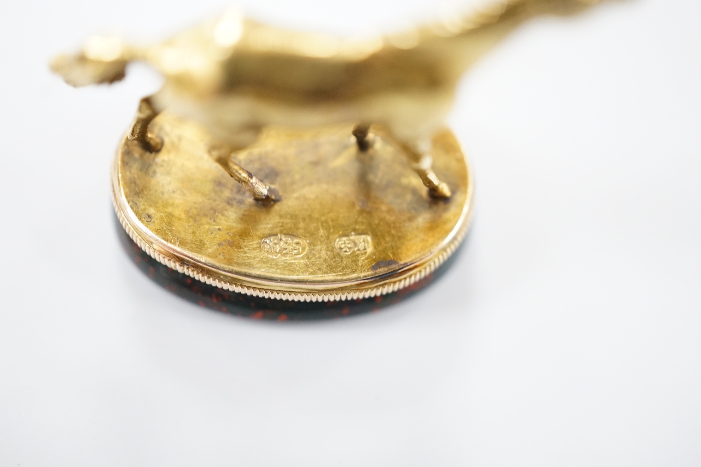 An early 20th century yellow metal and bloodstone set seal, with horse surmount